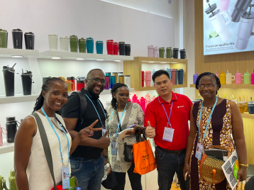Group of people standing in front of cup display