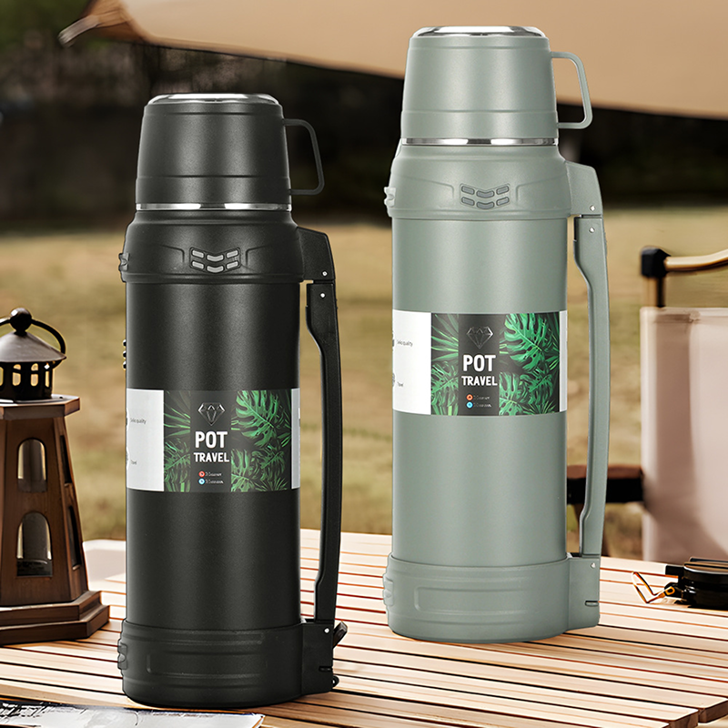 Two insulated travel pots on a wooden table