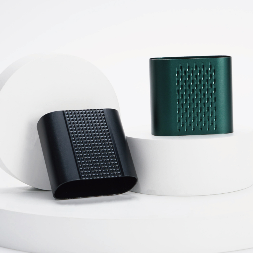 Two textured cylindrical objects on white platforms