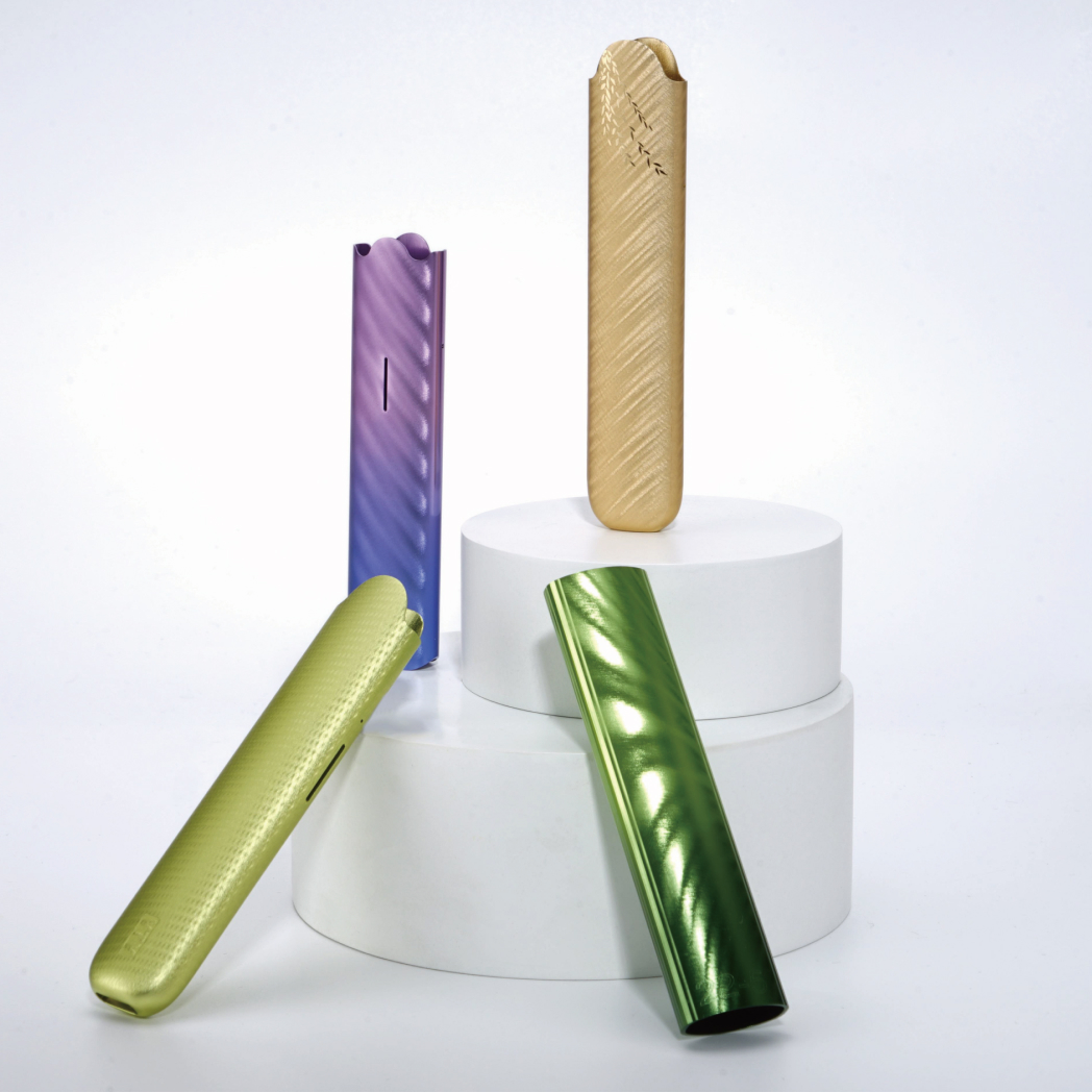 Four colorful cylindrical objects on white platforms