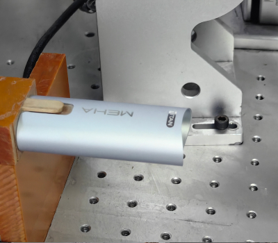 Silver cylindrical object on a metal surface