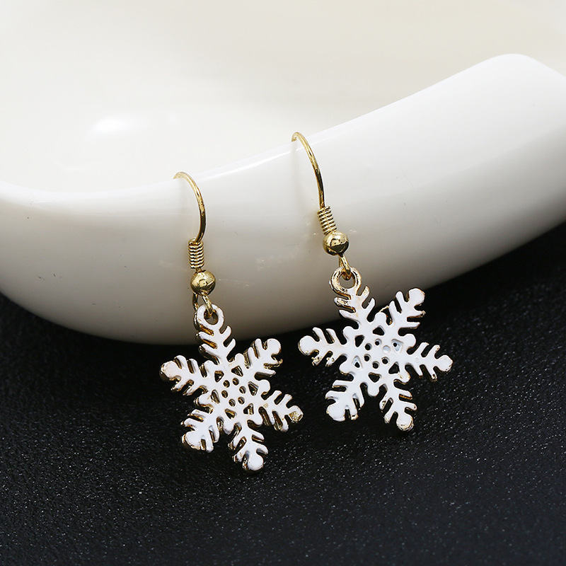 Wholesale White Alloy Paint Christmas Hollow Snowflake Earrings For Gifts Wholesale White Alloy Paint Christmas Hollow Snowflake Earrings For Gifts