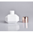 white bottle with gold cap