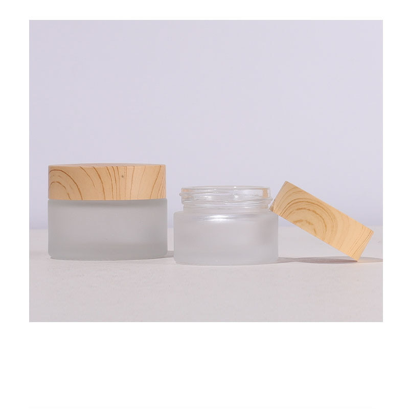 Custom Label Round Glass Jar 50g Cosmetic Packaging with Wooden Color Lid Frosted Glass Cosmetic Cream Jar