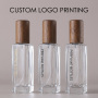 Wholesale Small Square Glass Perfume Bottle with Wooden Cap Refillable Empty Bottle for Essential Oil and Cosmetic Packaging