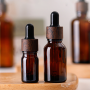 Wholesale Empty Cosmetic Amber Glass Body Oil 15ml 20ml 30ml Dropper Bottle with Wooden Grain Cap