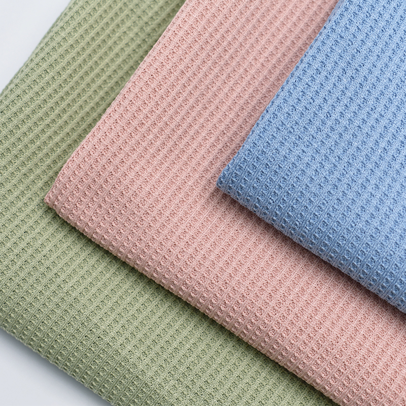 Superior quality stock lot 32S dyed solid cotton like polyester knitted waffle fabric for garment