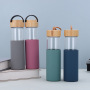 Custom 550ml Leak Proof Glass Water Bottle BPA Free Transparent Borosilicate Glass Bottle With Bamboo Lid and Silicone Sleeve