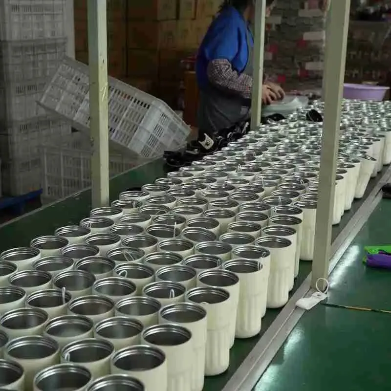Open stainless steel cup bodies arranged in rows during production