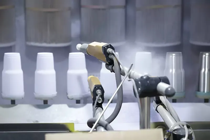 Robotic equipment handling white plastic bottle components