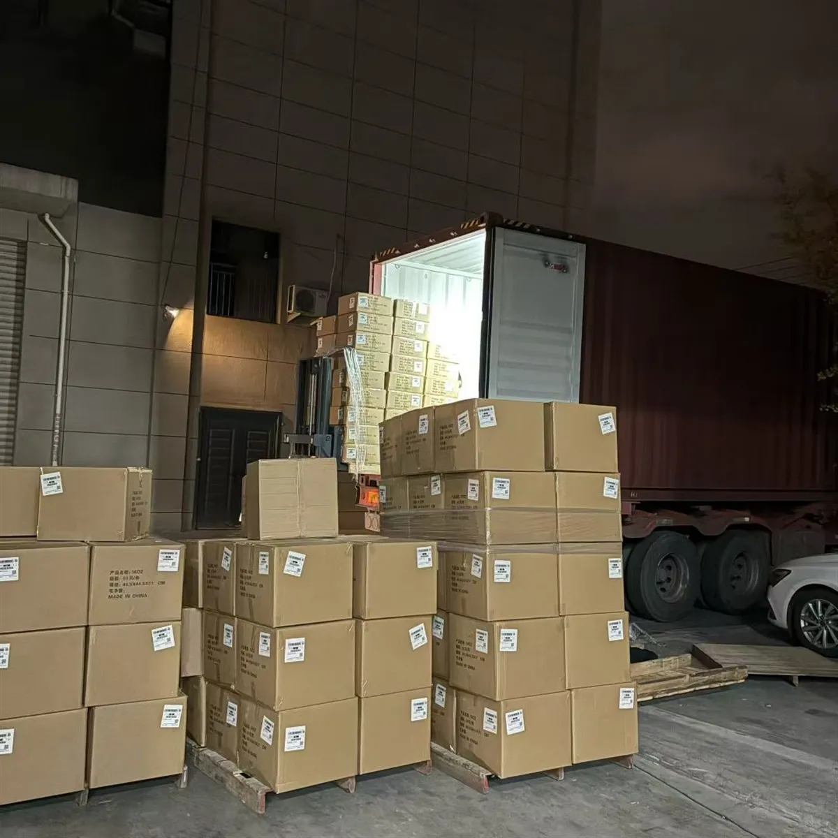 Custom drinkware cartons staged in a factory loading area before shipment