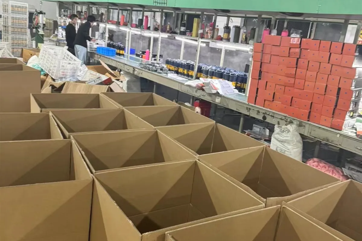 Corrugated carton dividers prepared for packed drinkware in a factory