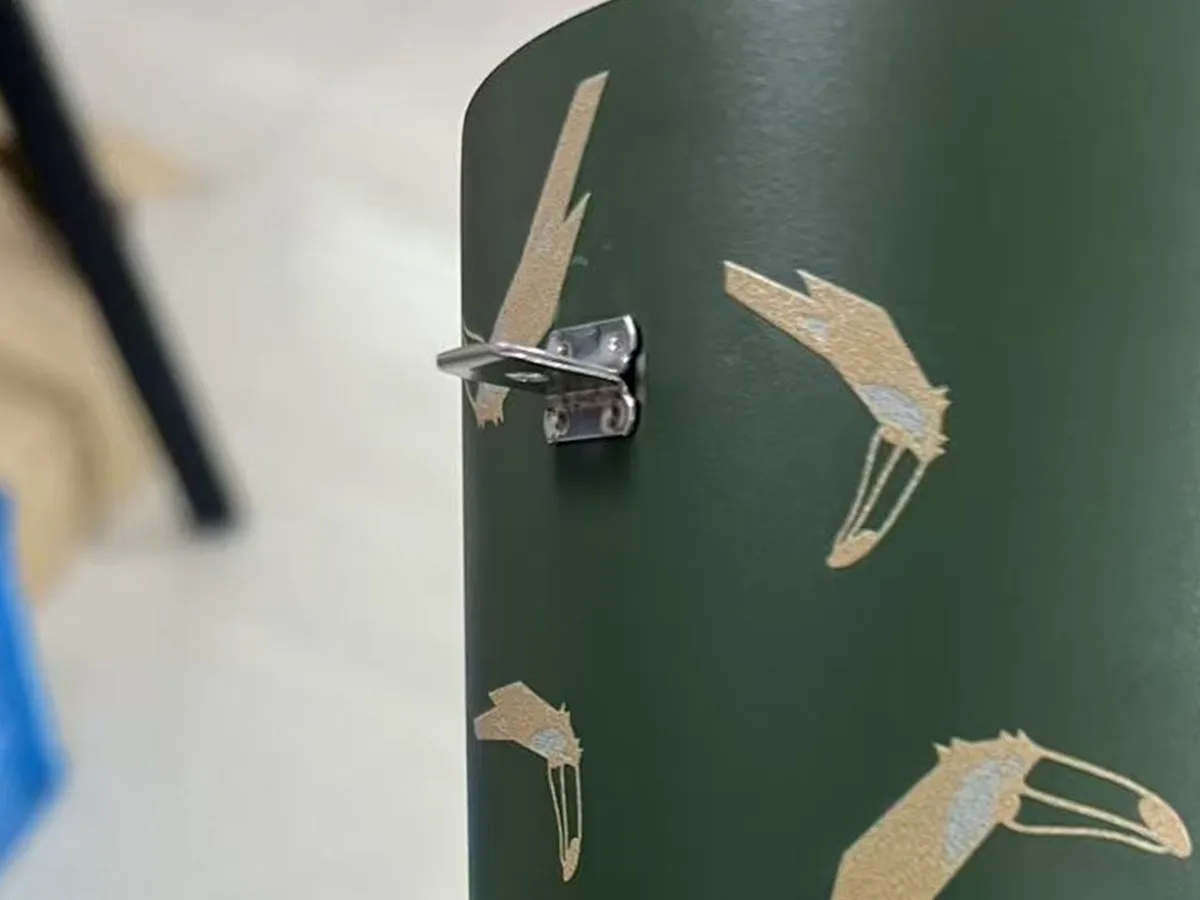 Welded metal handle mounting point exposed on a coated stainless steel tumbler body