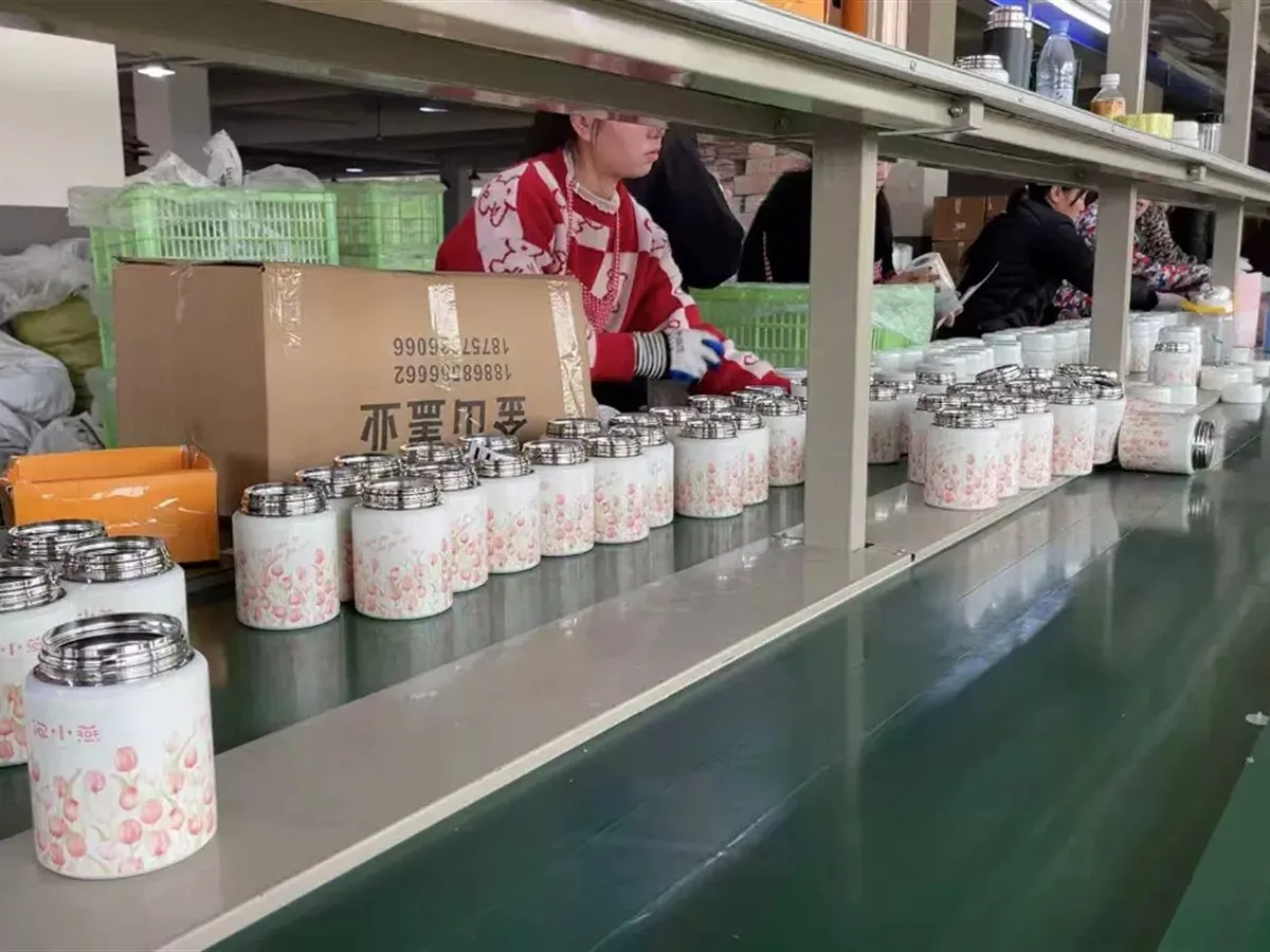 Finished tumblers arranged along a drinkware production inspection line