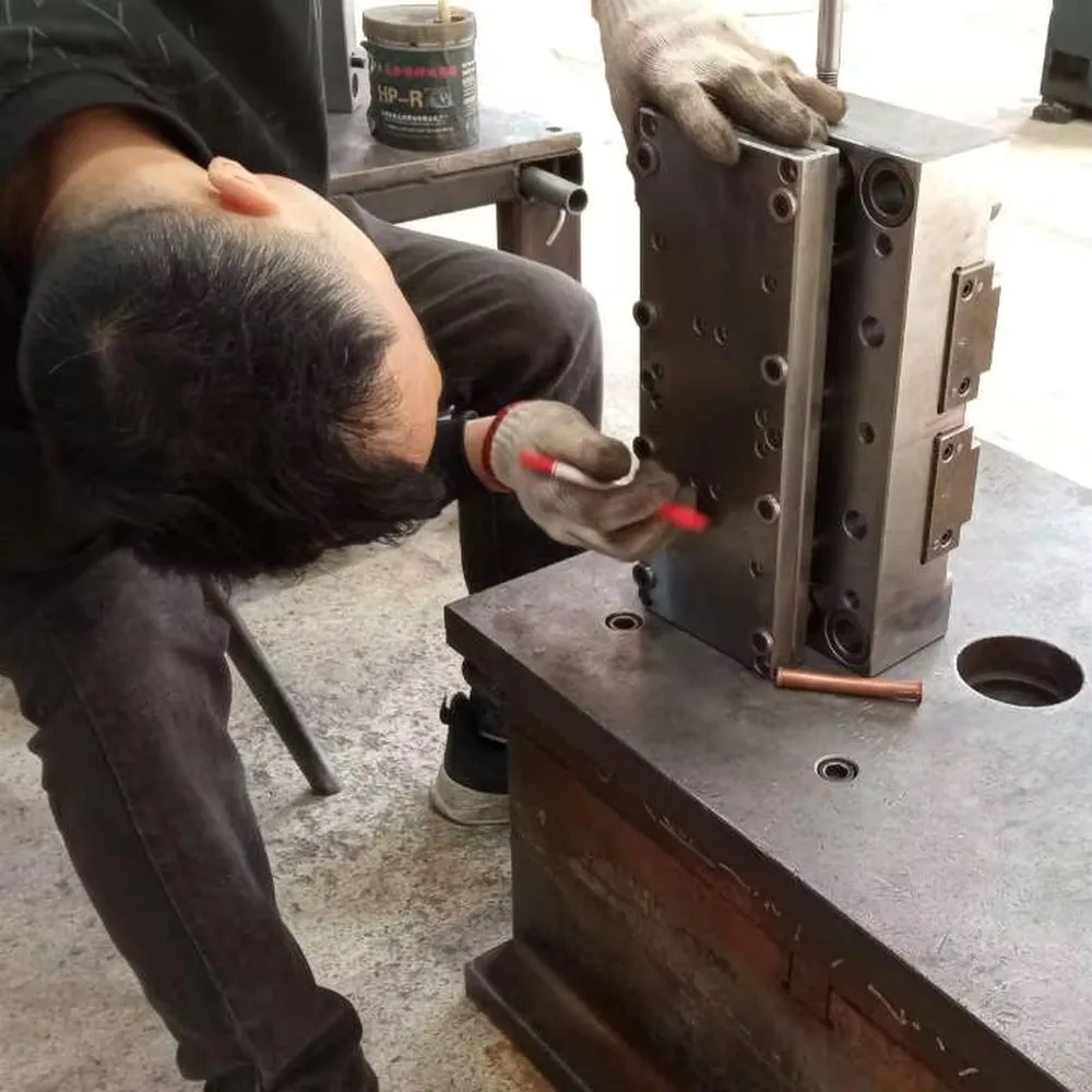 Production mold being inspected for custom drinkware components