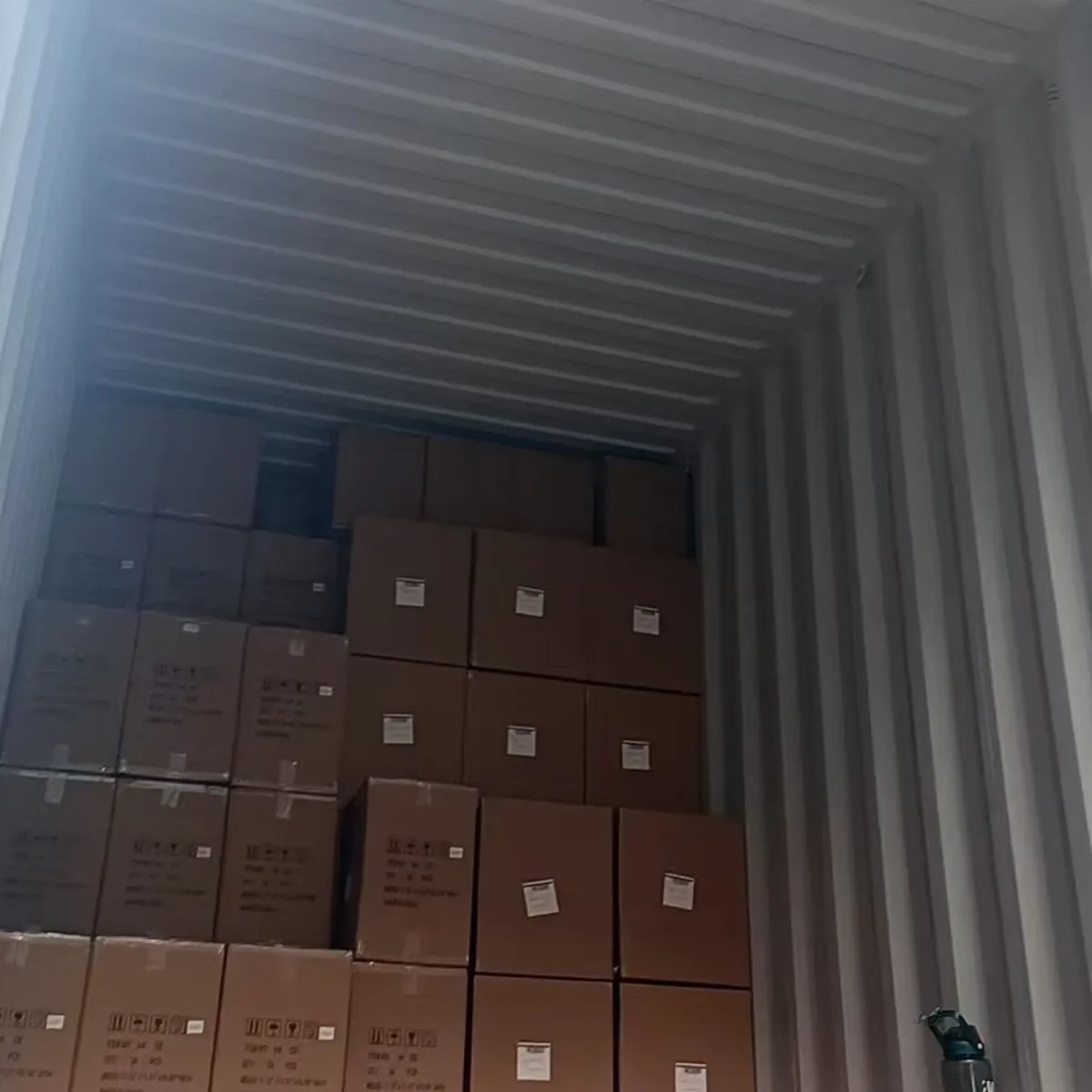 Packed cartons inside an open ocean shipping container