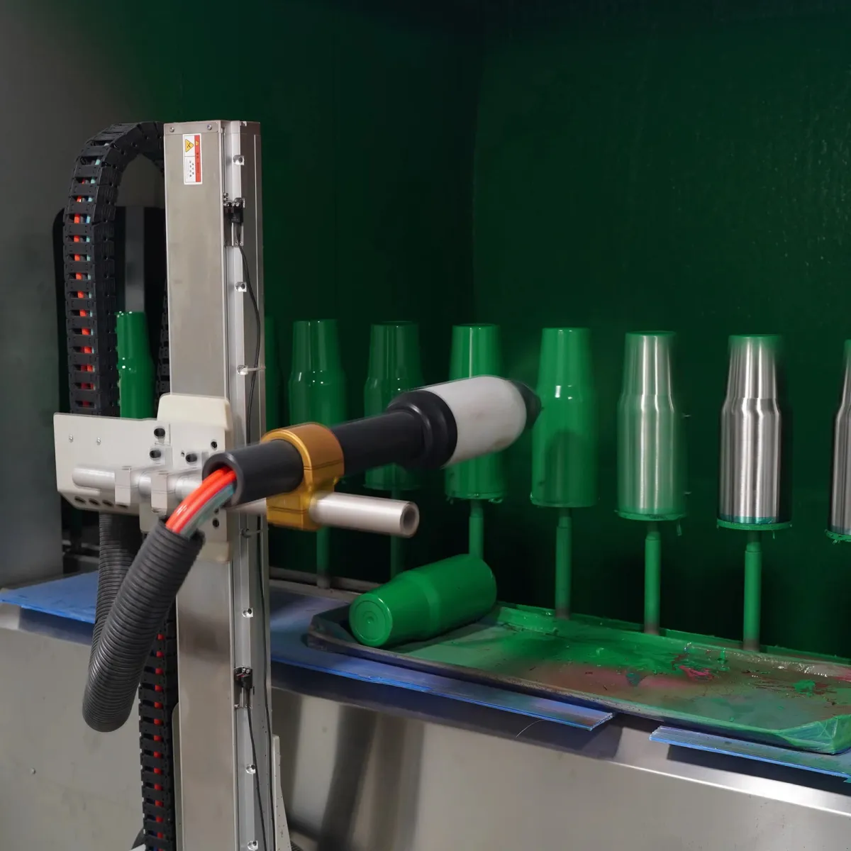 Tumbler bodies positioned at a factory powder coating station