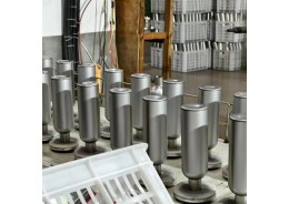 Unfinished stainless steel tumbler bodies arranged at a cup body forming line`