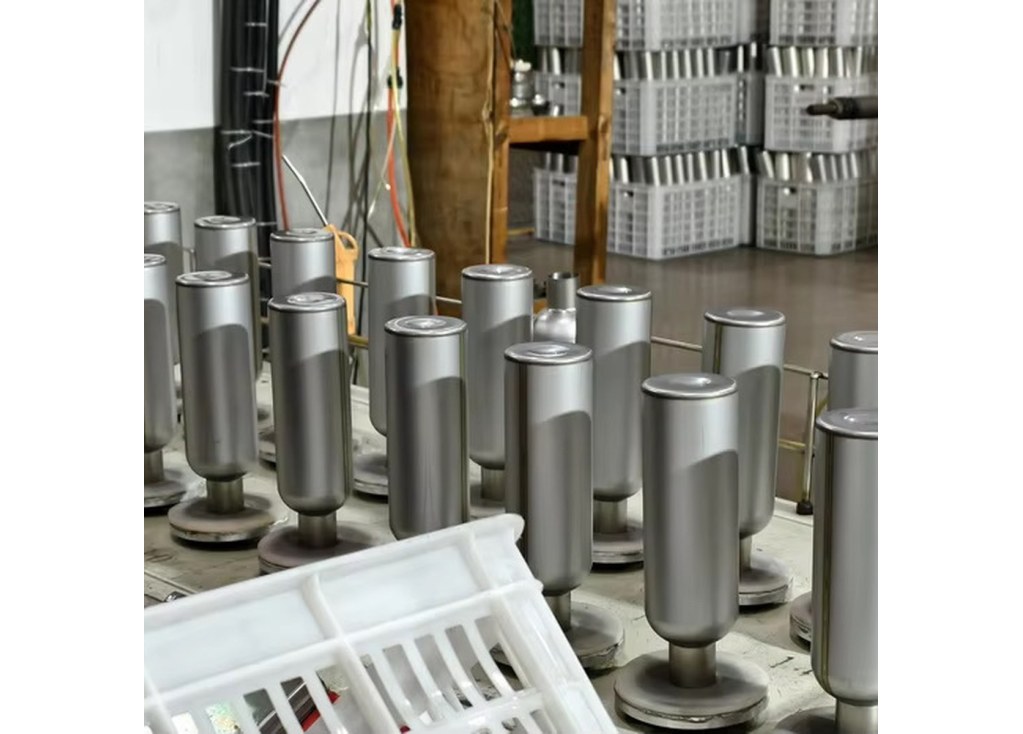Unfinished stainless steel tumbler bodies arranged at a cup body forming line`