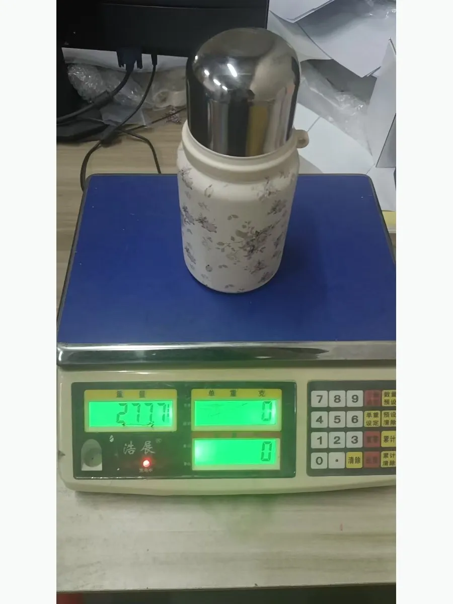 Matching stainless steel drinkware unit weighing 277 grams on the same production scale