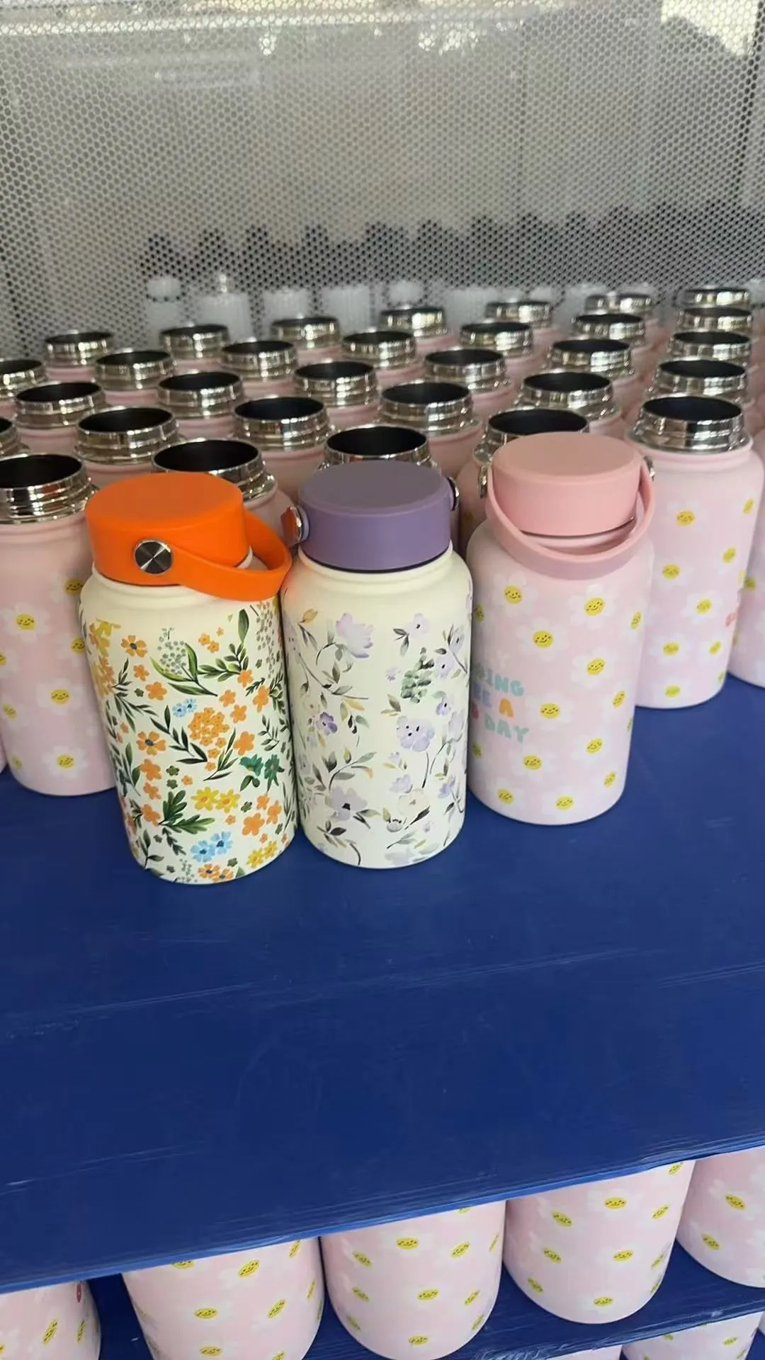 Decorated tumbler samples showing different colors, lids, and printed finishes