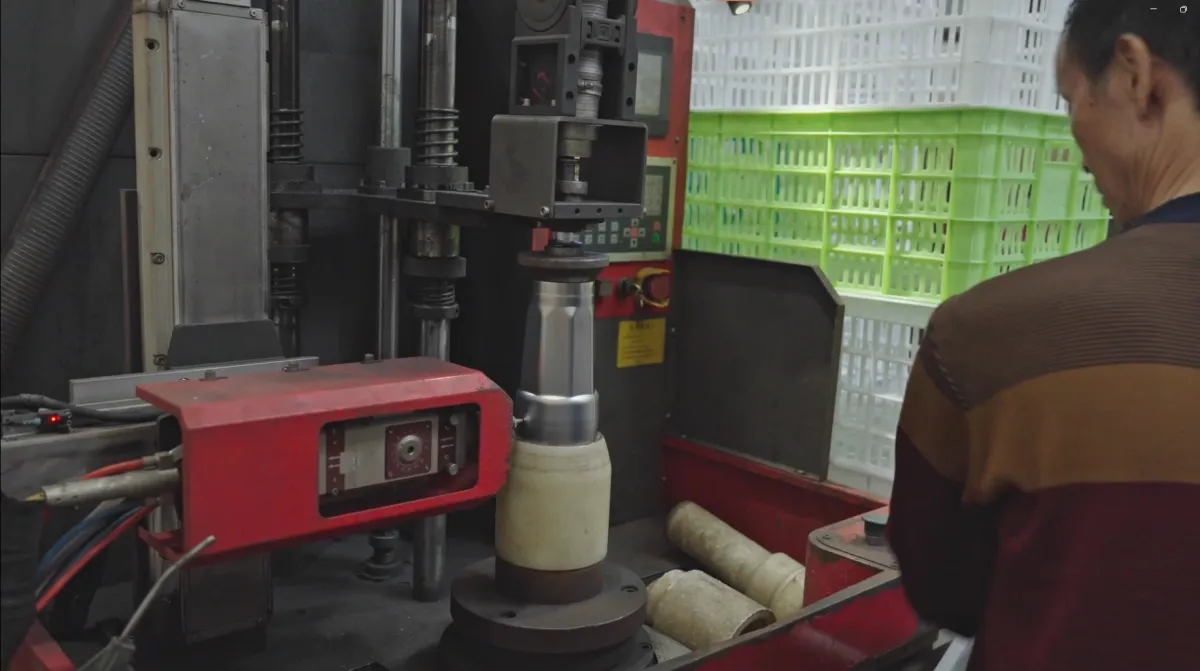 Machine processing the base area of a metal tumbler body