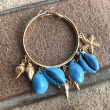turquoise and gold alloy charm