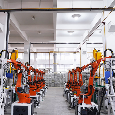 Industrial robotic arms on a drinkware manufacturing line